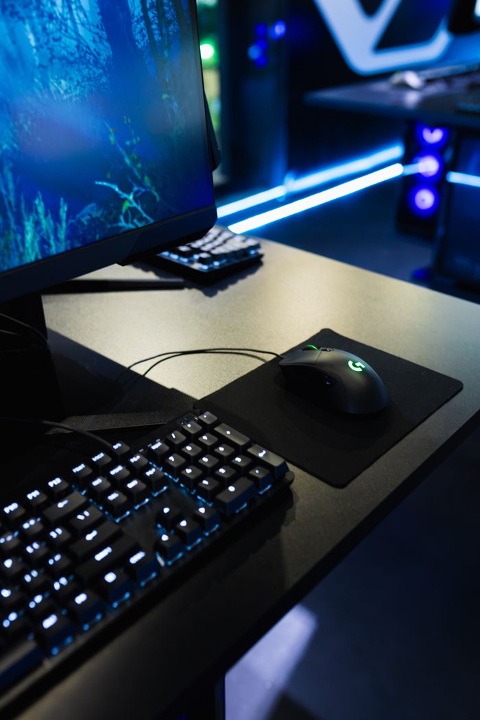 Crafting Captivating Headlines: Your awesome post title goes here Modern gaming station with an LED-lit keyboard and high-resolution monitor in a dark room.
